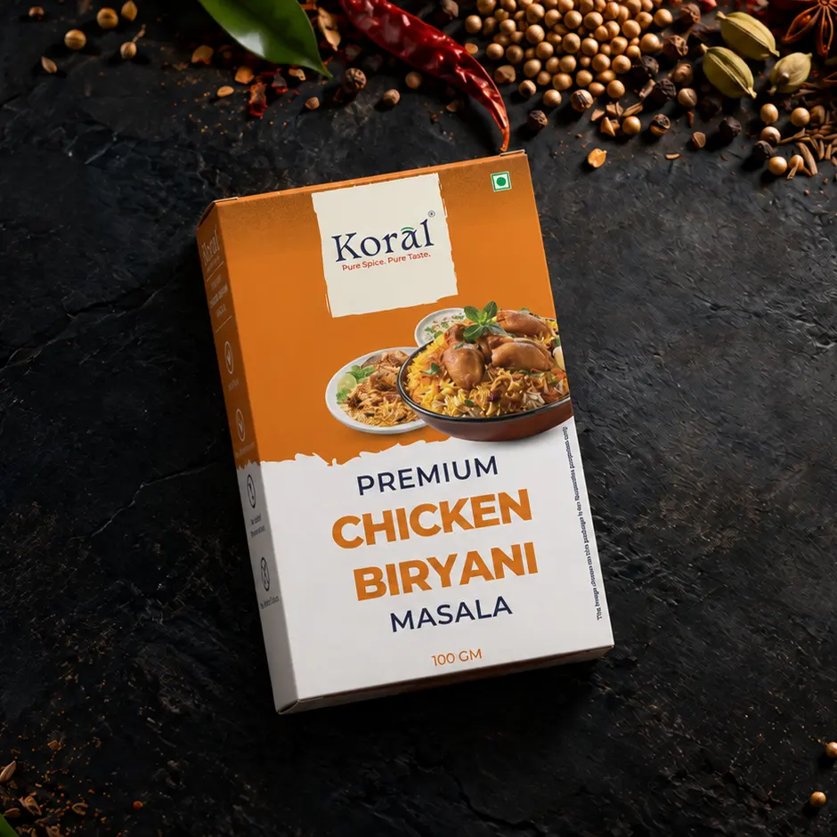 The Chicken Biryani Masala box lying on dark slate among whole spices