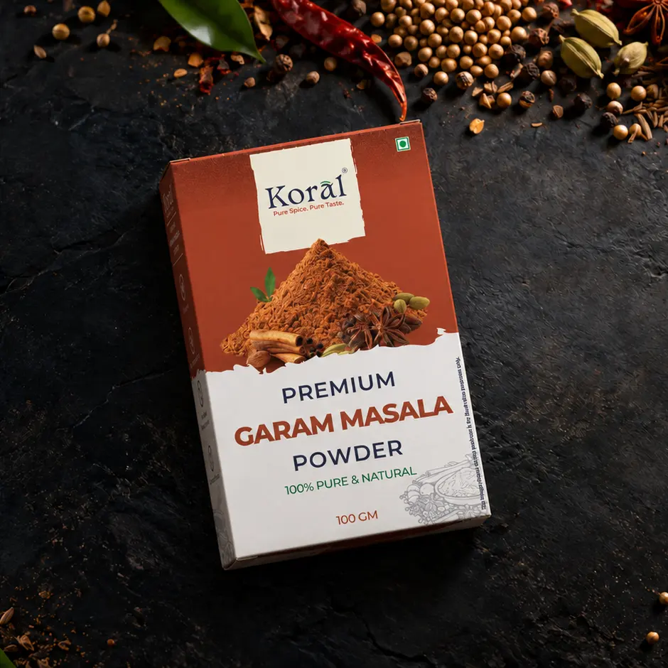 The Garam Masala Powder box lying on dark slate among whole spices